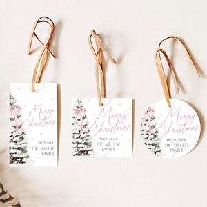 May include: Three Christmas gift tags with a watercolor illustration of a snowy pine tree with a pink ribbon. The tags are white with pink text that reads "Merry Christmas" and "With love, The Miller Family".