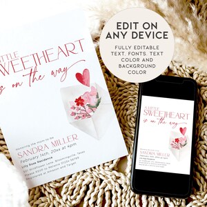 May include: A pink and red watercolour illustration of a heart and flowers in an envelope. The text "A Little Sweetheart is on the way" is written in a red script font. The text "Sandra Miller" is written in a black font. The text "February 14th, 20xx at 4pm" is written in a black font. The text "Lilly Rose Residence" is written in a black font. The text "301 Wildflower Lane, Bloomingville Texas" is written in a black font. The text "Please RSVP to Melanie 01234-56789" is written in a black font. The text "Registered at Amazon and Target" is written in a black font.
