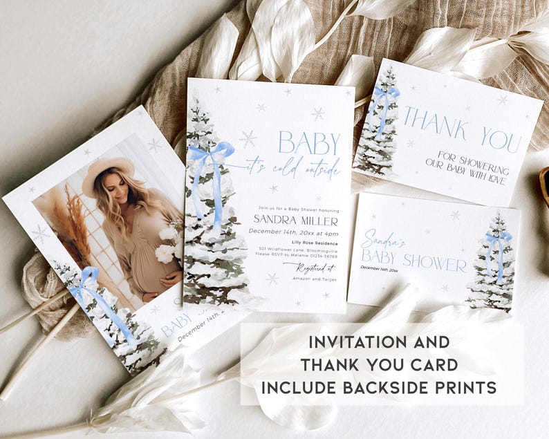 May include: Winter-themed baby shower invitation and thank you card set with a blue and white watercolor design featuring a snowy pine tree. The invitation includes the text "Baby it's cold outside" and the thank you card says "Thank you for showering our baby with love".