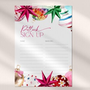 May include: A white Potluck Sign Up sheet with watercolor Christmas ornaments in pink, red, green, and gold. The text "Potluck Sign Up" is in a cursive font. The sheet has lines for name and what the person is bringing.