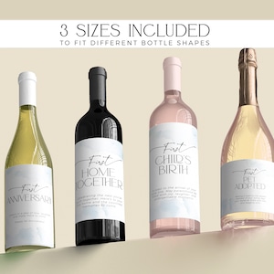 May include: Four wine bottles with labels that say "First Anniversary", "First Home Together", "First Child's Birth", and "First Pet Adopted". The labels have a watercolor background and are in a light blue color. The bottles are arranged in a row on a light brown surface. The text "3 Sizes Included" is at the top of the image, and the text "To Fit Different Bottle Shapes" is below it.