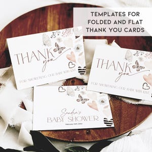 May include: Three thank you cards with a watercolor floral design featuring butterflies and hearts. The cards say "Thank you for showering our baby with love". One card also includes the text "Sandra's Baby Shower February 14th, 20xx".