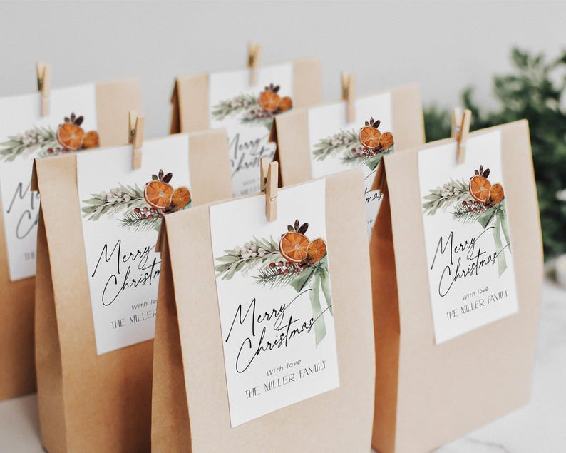 May include: A set of brown paper gift bags with tags that say "Merry Christmas" with a green and orange watercolor design. The tags also include the text "With love, The Miller Family".