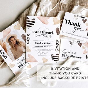 May include: A set of two printable baby shower cards with a watercolour heart design. The invitation card features the text "Our little sweetheart is on the way" and the thank you card features the text "Thank you for showering our baby with love".