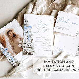 May include: A winter-themed bridal shower invitation and thank you card set. The invitation features a watercolor illustration of a snowy pine tree with a blue ribbon and the text "Snow in Love". The thank you card features the same illustration and the text "Thank you".