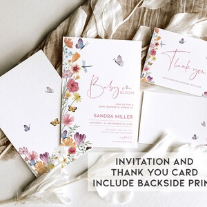 May include: A floral baby shower invitation and thank you card set. The invitation features a watercolor floral design with butterflies and the text "Baby in Bloom". The thank you card features the same floral design with the text "Thank you for showering our baby with love".