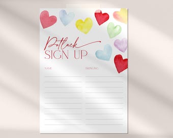 May include: A white sign with the text "Potluck Sign Up" in red cursive lettering. The sign has two columns labeled "Name" and "Bringing". The sign is decorated with watercolor hearts in various colors, including red, yellow, blue, green, and pink.
