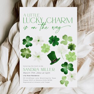 A little lucky charm is on the way baby shower invitation with green shamrocks and leprechaun hat for St Patricks Day