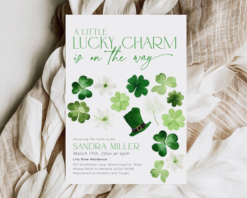 A little lucky charm is on the way baby shower invitation with green shamrocks and leprechaun hat for St Patricks Day