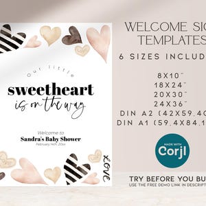K&ouml;nnte beinhalten: Druckbare Willkommens-Schildvorlage f&uuml;r eine Babyparty. Das Schild zeigt ein Aquarelldesign mit Herzen in den Farben Rosa, Braun und Schwarz. Der Text lautet "Unser kleiner Liebling ist unterwegs" und enth&auml;lt den Namen "Sandras Babyparty" und das Datum "14. Februar 20xx". Das Schild ist in sechs Gr&ouml;&szlig;en erh&auml;ltlich, darunter 8x10 Zoll, 18x24 Zoll, 20x30 Zoll, 24x36 Zoll, DIN A2 (42x59,4 cm) und DIN A1 (59,4x84,1 cm).