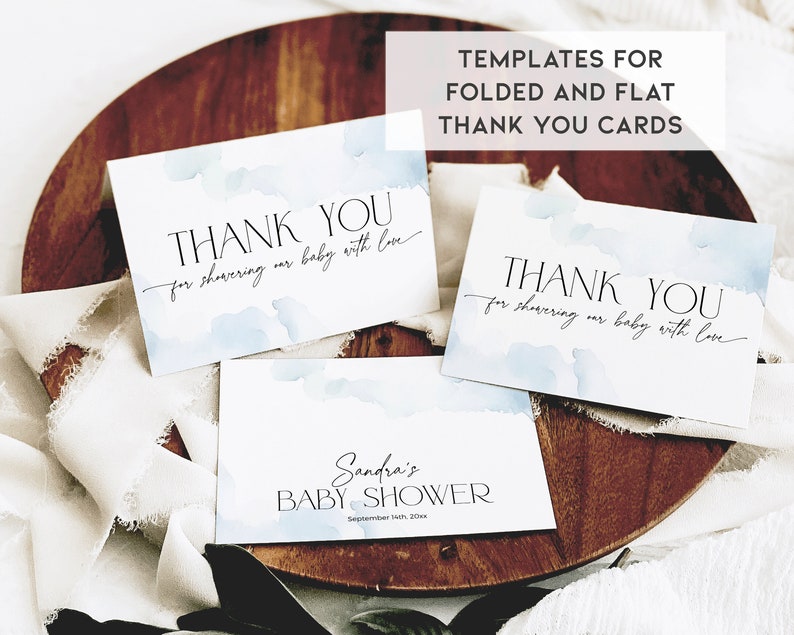May include: White thank you cards with blue watercolor accents and elegant script. The cards read "THANK YOU for showering our baby with love." One card says "Sandra's BABY SHOWER." The image also includes the text "TEMPLATES FOR FOLDED AND FLAT THANK YOU CARDS."