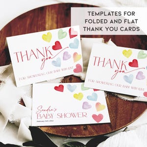 May include: Three printable thank you cards with watercolor hearts in shades of pink, yellow, blue, and green. The cards say "Thank you for showering our baby with love".
