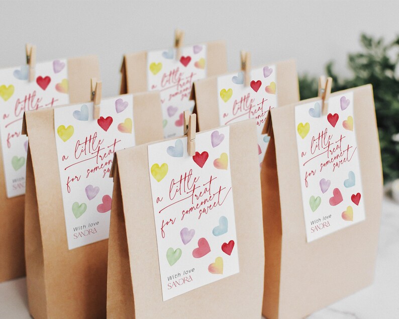 May include: A set of brown paper bags with colorful heart-shaped stickers that say "a little treat for someone sweet" and "with love SANDRA".