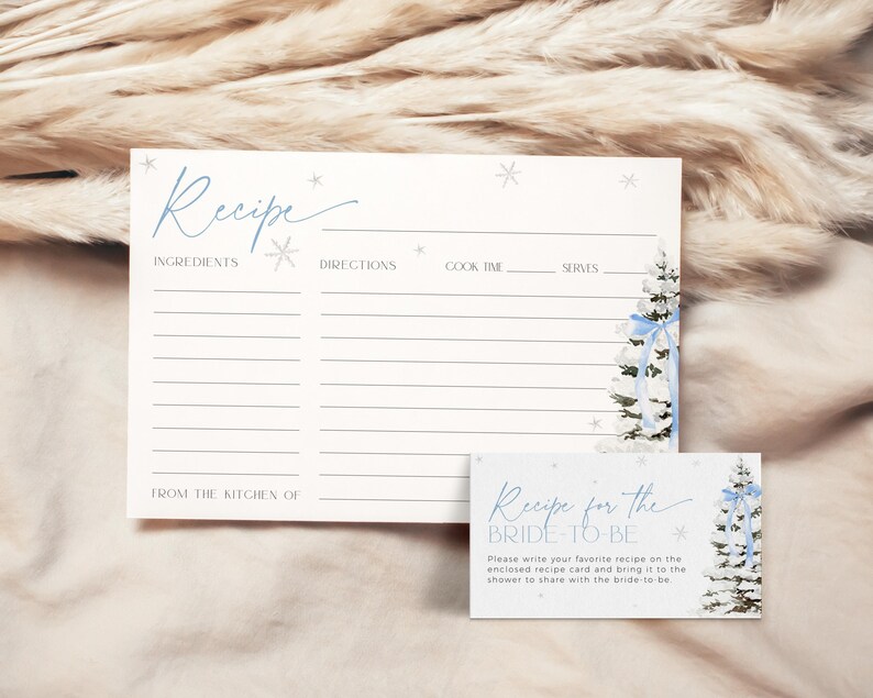 May include: A printable recipe card with a wintery blue and white design. The card has a space for the recipe title, ingredients, directions, cook time, and servings. The text "Recipe for the Bride-to-Be" is on a smaller card with a similar design.