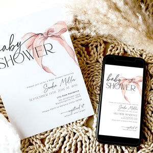 May include: A pink and white baby shower invitation with a watercolor bow and the text "baby shower" in black script. The invitation includes the name "Sandra Miller" and the date and time of the event. The invitation also includes the address and RSVP information. The invitation is displayed on a phone screen and a printed copy is on a woven surface.