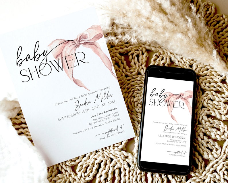 May include: A pink and white baby shower invitation with a watercolor bow and the text "baby shower" in black script. The invitation includes the name "Sandra Miller" and the date and time of the event. The invitation also includes the address and RSVP information. The invitation is displayed on a phone screen and a printed copy is on a woven surface.