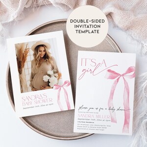 May include: Double-sided baby shower invitation template with a pink watercolor bow and the text "It's a girl". The back of the card features a photo of a pregnant woman and the text "Sandra's Baby Shower" with the date and time.