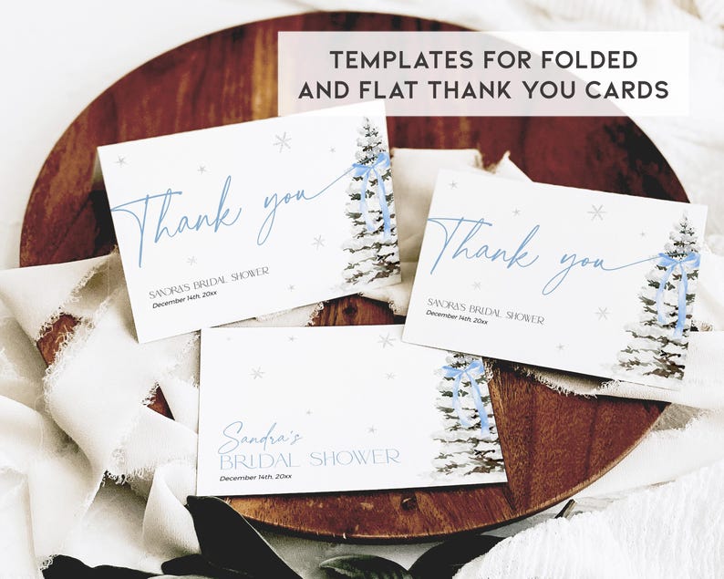 May include: Three printable thank you cards with a winter theme. The cards feature a watercolor illustration of a snowy pine tree with a blue ribbon. The text on the cards reads "Thank you" and includes the text "Sandra's Bridal Shower" and "December 14th, 20xx".