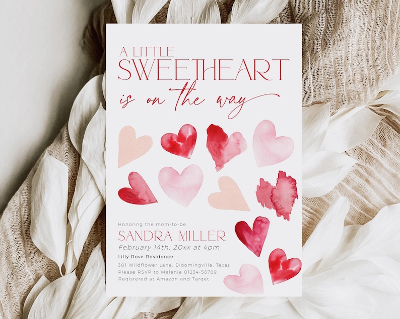 May include: A baby shower invitation with a watercolor design featuring pink and red hearts. The text reads "A Little Sweetheart is on the way" and includes the name Sandra Miller, the date February 14th, the time 4pm, and the location Lilly Rose Residence.