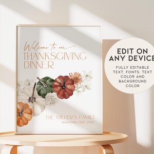 May include: A framed Thanksgiving dinner sign with the text "Welcome to our Thanksgiving Dinner" in copper-colored script. The sign features watercolor pumpkins and flowers. Additional text reads "Edit on any device".