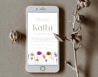 May include: A digital invitation for a birthday party. The invitation is for a girl named Kathi who is turning two. The invitation features a floral design with a green background and the text "Our Little Wildflower Kathi is Turning Two. Saturday, 22 September 2023 at Two O'Clock. 360 Sunny Lane Sun City. Kindly RSVP to Kathi's Mom."