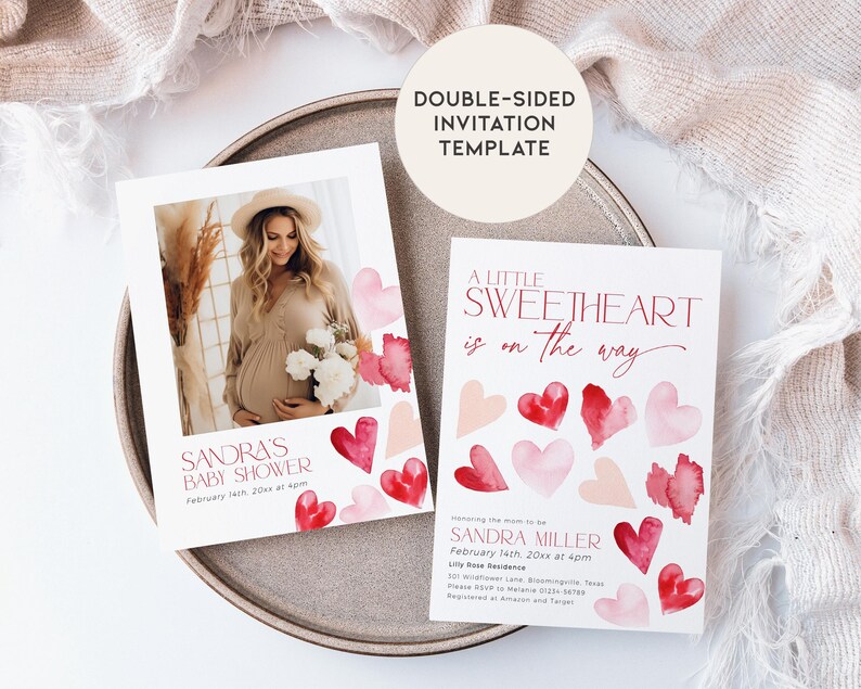 May include: Double-sided baby shower invitation template with a watercolor design of pink and red hearts. The front of the invitation features a photo of a pregnant woman and the text "Sandra's Baby Shower". The back of the invitation features the text "A Little Sweetheart is on the way" and the date and time of the shower.