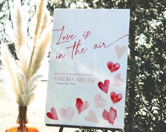 Modelo de placa de boas-vindas para chá de panela de dia dos namorados, sinalização Coquette Love is in the Air, decoração de despedida de solteira de fevereiro com corações vermelhos e rosas, CH84