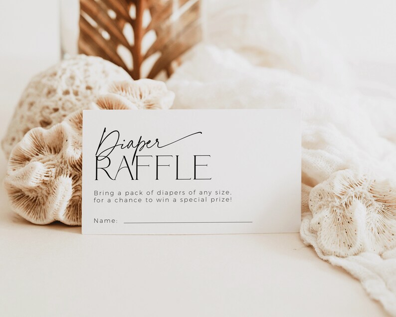 May include: A white card with black text that reads "Diaper Raffle" and "Bring a pack of diapers of any size, for a chance to win a special prize!" with a blank line for a name.