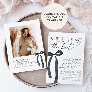 May include: Double-sided bridal shower invitation template with a black and white design. The front features a photo of the bride-to-be and the text "Sandra's Bridal Shower". The back features a black ribbon bow and the text "She's tying the knot" with details about the shower.