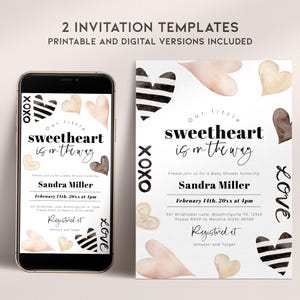 May include: Two printable baby shower invitation templates featuring a watercolour design with hearts in shades of pink, brown, and black. The text reads "Our little sweetheart is on the way" and includes the date, time, and location of the event. The invitations also include the text "Registered at Amazon and Target".