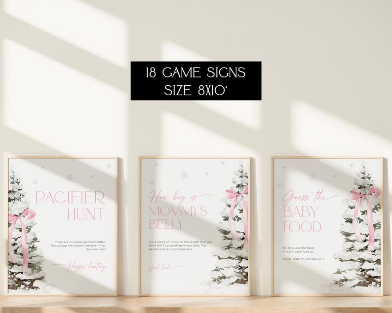 May include: Three printable 8x10 inch signs for a baby shower game. The signs feature a wintery forest scene with a pink ribbon and text that reads "Pacifier Hunt", "How big is Mommy's Belly?" and "Guess the Baby Food".
