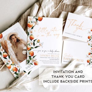 May include: A set of two baby shower cards with a floral design featuring orange blossoms and fruit. The invitation card says "A little cutie is on the way" and the thank you card says "Thank you" with the text "Sandra's Baby Shower".