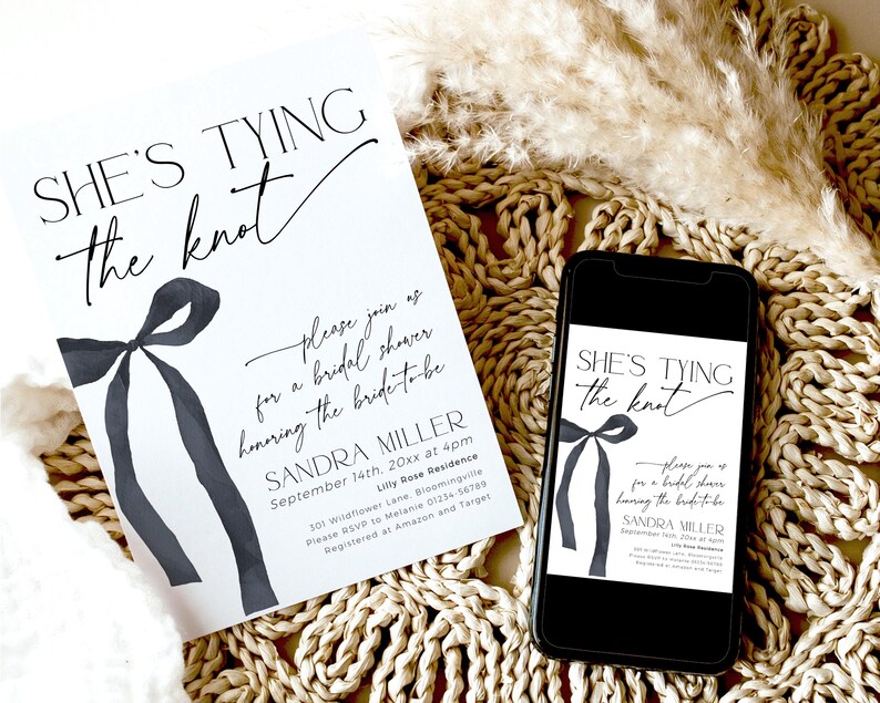 May include: A white bridal shower invitation with black calligraphy text that reads "She's Tying the Knot". The invitation features a watercolor illustration of a black bow. The text also includes the bride's name, the date, time, and location of the shower.