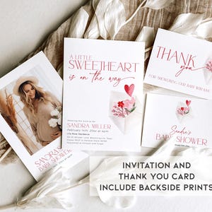 May include: A pink and white watercolor floral design with a heart on a white baby shower invitation card. The text on the card reads "A little sweetheart is on the way" and "Sandra Miller, February 14th, 20xx at 4pm". A matching thank you card reads "Thank you for showering our baby with love" and "Sandra's Baby Shower".
