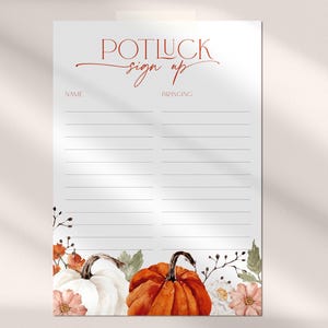 May include: A white paper sign-up sheet with the words "POTLUCK sign up" in red script. The sign features a watercolor design of pumpkins and floral accents in shades of orange, white, and pink. Lines are provided for names and what people are bringing.