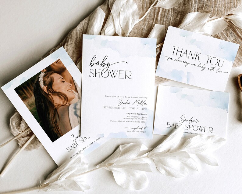 May include: A collection of baby shower invitations and thank you cards. The cards feature a watercolor design with soft blue accents and elegant black text. One card includes a photo of a smiling person. The text includes the words "baby shower" and "thank you".