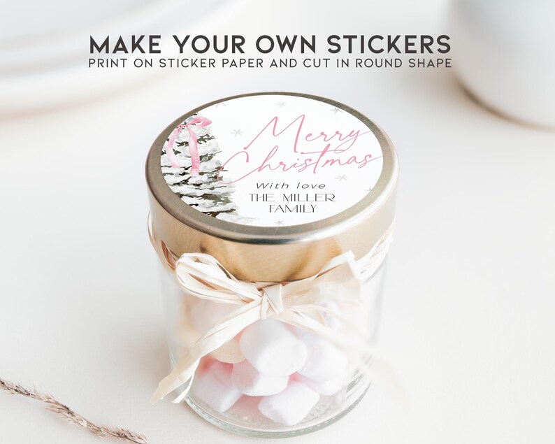 May include: A glass jar filled with white marshmallows, tied with a beige ribbon, and topped with a round sticker that reads "Merry Christmas" in pink script with the text "With love THE MILLER FAMILY" below.