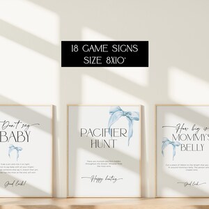 May include: Three printable baby shower game signs with blue ribbon illustrations. The signs are 8x10 inches and include the text "Don't say baby", "Pacifier Hunt", and "How big is Mommy's Belly".