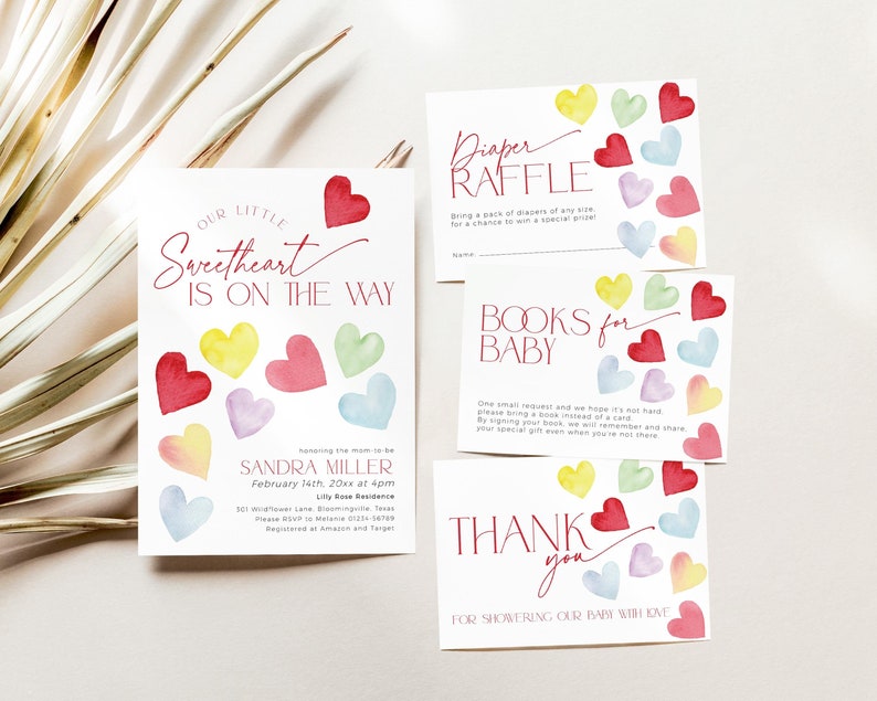 May include: A baby shower invitation with a watercolor design of hearts in various colors. The text reads "Our Little Sweetheart Is On The Way" and includes the date, time, and location of the event. The invitation also includes information about a diaper raffle and a request for guests to bring a book for the baby.