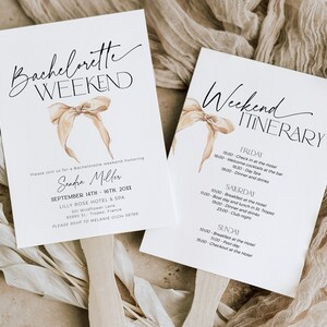 May include: A white card with a beige bow and the text "Bachelorette Weekend" in black cursive. The card also includes the text "Please join us for a Bachelorette weekend honouring Sandra Miller September 14th - 16th, 2011 Lilly Rose Hotel & Spa 301 Wildflower Lane 83990 51 Tropez, France Please RSVP to Melanie 01234-56789". A second white card with a beige bow and the text "Weekend Itinerary" in black cursive. The card also includes the text "Friday 15:00 - Check in at the Hotel 16:00 - Welcome cocktails at the bar 16:30 - Day Spa 19:00 - Dinner and drinks Saturday 10:00 - Breakfast at the Hotel 11:00 - Boat day and lunch in St Tropez 19:00 - Dinner and drinks 23:00 - Club night Sunday 10:00 - Breakfast at the Hotel 11:00 - Pool day 15:00 - Checkout at the Hotel".