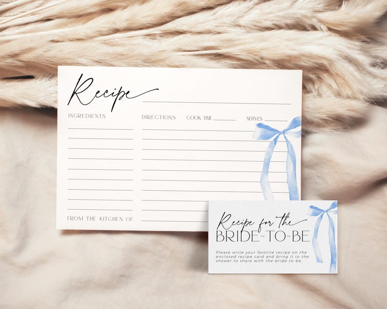 May include: A printable recipe card with a blue watercolor ribbon design. The card has sections for ingredients, directions, cook time, and servings. The text "Recipe for the Bride-to-Be" is on a separate card with a blue watercolor ribbon design.