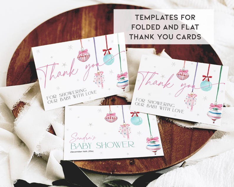 May include: Three printable thank you cards featuring a pink and blue Christmas ornament design. The text on the cards reads "Thank you for showering our baby with love".