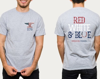 May include: A gray t-shirt with a patriotic design. The front features an anvil with an American flag and the number 1776. The back displays the words "RED WHITE & BLUE" and "AMERICAN FARRIER" in red, white, and blue.