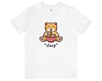 May include: White t-shirt with a cartoon illustration of an orange cat eating noodles from a pink bowl. The text *slurp* is printed below the cat.