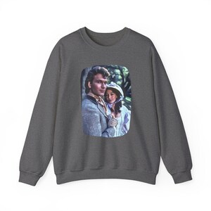May include: A dark gray sweatshirt with a printed image of a couple in a romantic embrace. The image is framed in a rounded rectangle and features a man with dark hair and a woman with light hair.
