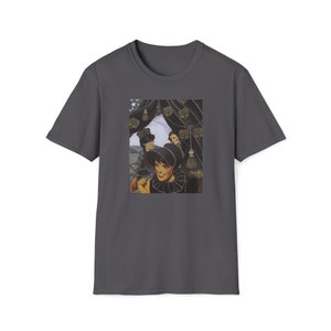 May include: A dark gray t-shirt with a vintage-style image of three women in black hats and dresses. The image is set against a backdrop of a dark curtain with gold tassels.