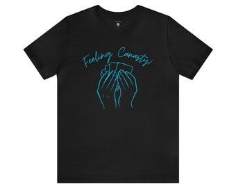May include: Black t-shirt with a blue outline of hands holding a deck of cards and the text "Feeling Canasty!"