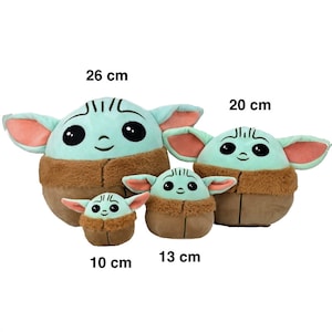 May include: Four plush toys of a popular character from the Star Wars franchise. The toys are different sizes, measuring 10 cm, 13 cm, 20 cm, and 26 cm. The toys are green and brown with large eyes and a smiling face.
