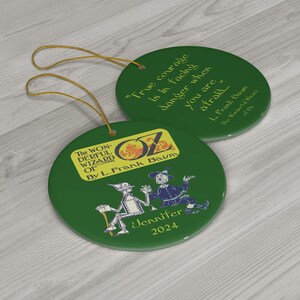 two green christmas ornaments with a yellow tag on them