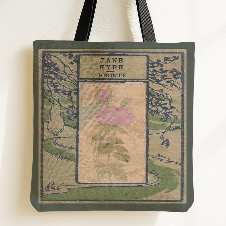 May include: A tote bag featuring a book cover design for Jane Eyre by Bronte. The graphic displays a central rectangular panel with a pink rose illustration, surrounded by a green landscape with trees and a winding path. It has black straps.